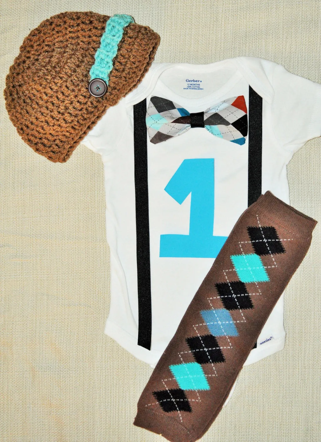 boy argyle brown and teale cake smash bowtie bodysuit and suspenders with Birthday number argyle baby leg warmers and brown & teal hat