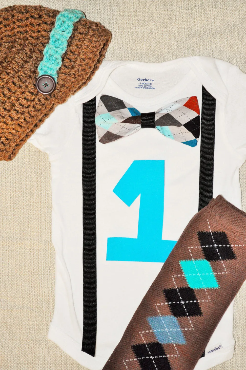 boy argyle brown and teale cake smash bowtie bodysuit and suspenders with Birthday number argyle baby leg warmers and brown & teal hat